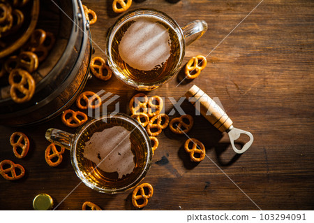 Beer in glasses with salted pretzels. Beer in glasses with salted pretzels. 103294091