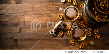 Beer in glasses with salted pretzels. Beer in glasses with salted pretzels. 103294092