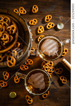 Beer in glasses with salted pretzels. Beer in glasses with salted pretzels. 103294093