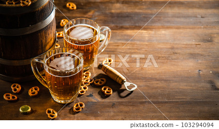 Beer in glasses with salted pretzels. Beer in glasses with salted pretzels. 103294094