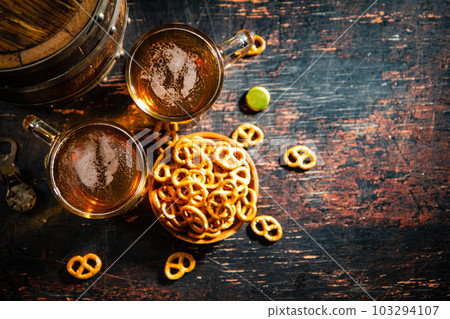 Beer in glasses with salted pretzels. Beer in glasses with salted pretzels. 103294107