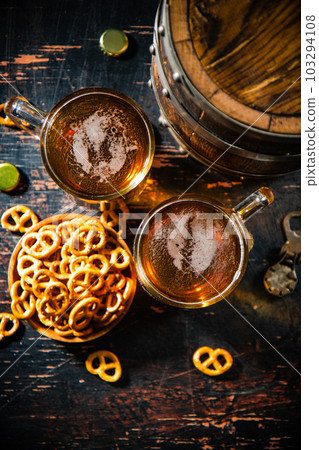 Beer in glasses with salted pretzels. Beer in glasses with salted pretzels. 103294108