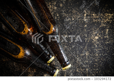 Fresh beer in closed bottles. 103294172