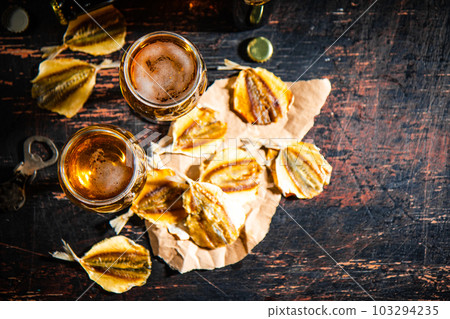 Beer and dried fish. 103294235