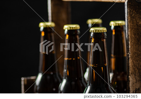 Beer bottles in an old box. 103294365
