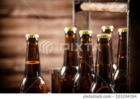 Beer bottles in an old box. Beer bottles in an old box. 103294394