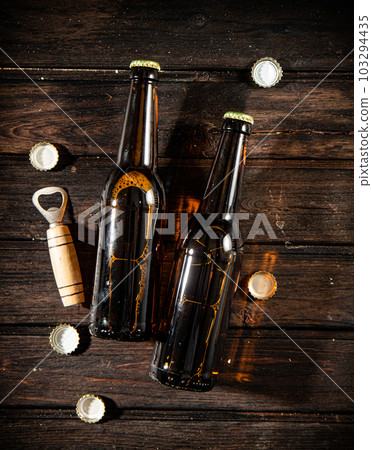 Bottles with beer and opener. Bottles with beer and opener. 103294435