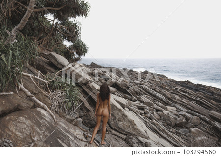 Wild Rocky Beach Landscape with Nudist Beach Woman 103294560
