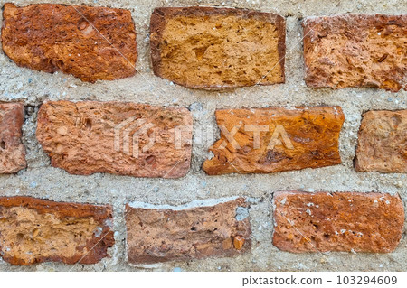 The texture of the red brick wall of an old building. The texture of the red brick wall of an old building. 103294609