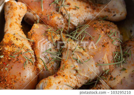 Raw chicken legs with spices. Marinated chicken with rosemary and paprika. Uncooked meat. Raw meat in bowl. Homemade barbecue. Meat and herbs. Raw chicken legs with spices. Marinated chicken with rosemary and paprika. Uncooked meat. Raw meat in bowl. Homemade barbecue. Meat and herbs. 103295210
