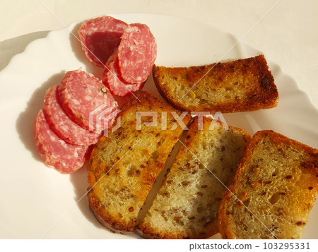 Fried croutons with sausage on a plate Fried croutons with sausage on a plate 103295331