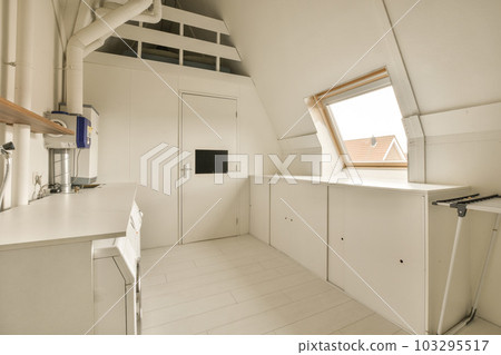 a kitchen area in an attic style house with white walls and wood trim on the ceiling, windows, and skylights a kitchen area in an attic style house with white walls and wood trim on the ceiling, windows, and skylights 103295517