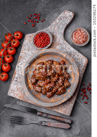 Chicken hearts fried in soy sauce with salt and spices in a plate 103296274