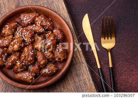 Chicken hearts fried in soy sauce with salt and spices in a plate 103296307