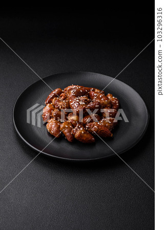 Chicken hearts fried in soy sauce with salt and spices in a plate 103296316
