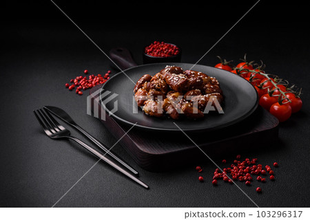 Chicken hearts fried in soy sauce with salt and spices in a plate 103296317