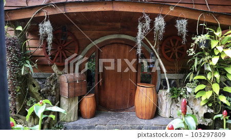 Hobbit House with round doors, barrels, treasure chest, nature plant and other decorations. Hobbit House with round doors, barrels, treasure chest, nature plant and other decorations. 103297809