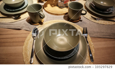 Dinning table set at home, tableware, glasses, spoon and fork. Dinning table set at home, tableware, glasses, spoon and fork. 103297829