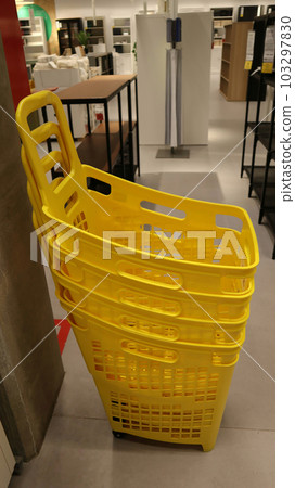 Yellow shopping baskets at shopping mall. Yellow shopping baskets at shopping mall. 103297830