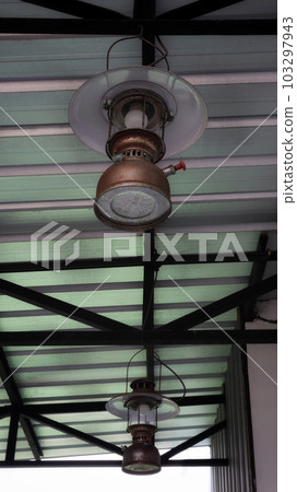 Vintage old hanging storm lantern at the ceiling. 103297943