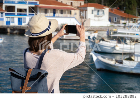 Girl takes a beautiful photo during her travel. 103298892