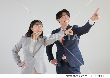 Business woman and businessman pointing far away_1 103299063