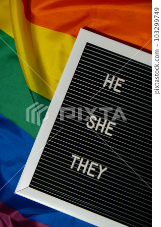 HE SHE THEY text Neo pronouns concept on Rainbow flag background gender pronouns. Non-binary people rights transgenders. Lgbtq community support assume my gender tolerance equal rights HE SHE THEY text Neo pronouns concept on Rainbow flag background gender pronouns. Non-binary people rights transgenders. Lgbtq community support assume my gender tolerance equal rights 103299749