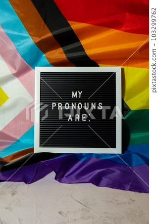 MY PRONOUNS ARE text Neo pronouns concept on Rainbow flag background gender pronouns. Non-binary people rights transgenders. Lgbtq community support assume my gender tolerance equal rights MY PRONOUNS ARE text Neo pronouns concept on Rainbow flag background gender pronouns. Non-binary people rights transgenders. Lgbtq community support assume my gender tolerance equal rights 103299762