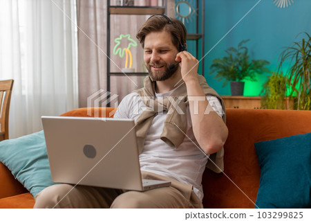 Young man freelance worker call center or support service operator helpline having talk with client 103299825