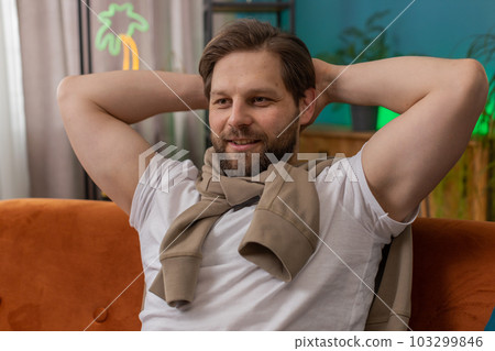 Tired young man lying down on comfortable couch, taking a rest, daytime nap relaxing falling asleep 103299846