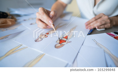 Faceless woman sketches swimwear and underwear. Close-up of fashion designer's hands. 103299848
