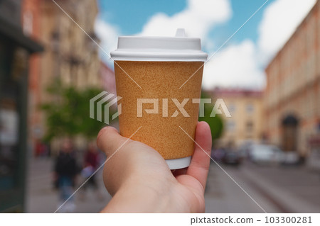 paper cup of natural coffee in women's hand against of center of St. Petersburg, Russia paper cup of natural coffee in women's hand against of center of St. Petersburg, Russia 103300281