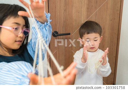 A child playing with a cradle Image of old-fashioned play A child playing with a cradle Image of old-fashioned play 103301758