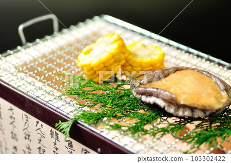 Live abalone dancing and grilling 103302422