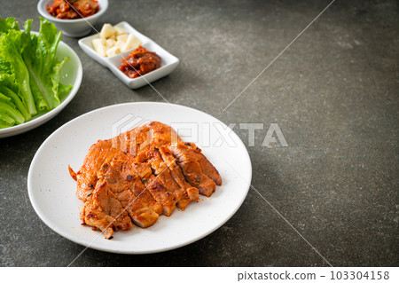 grilled pork marinated Kochujang sauce in Korean style with vegetable and kimchi grilled pork marinated Kochujang sauce in Korean style with vegetable and kimchi 103304158