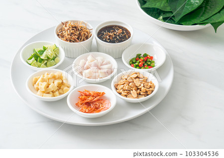 Miang kham - A royal leaf wrap appetizer Miang kham - A royal leaf wrap appetizer 103304536