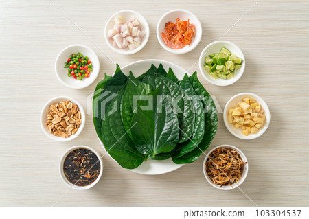 Miang kham - A royal leaf wrap appetizer Miang kham - A royal leaf wrap appetizer 103304537