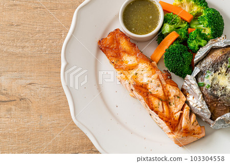 grilled salmon steak with bake potato grilled salmon steak with bake potato 103304558