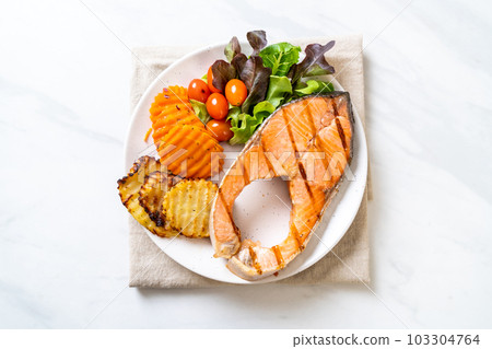 grilled salmon steak fillet with vegetable and french fries grilled salmon steak fillet with vegetable and french fries 103304764