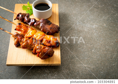 Japanese chicken grill or yakitori serve in izakaya style Japanese chicken grill or yakitori serve in izakaya style 103304891