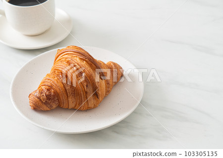 fresh croissant on white plate 103305135