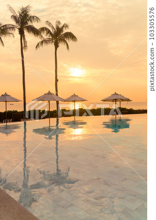 umbrella with bed pool around swimming pool with ocean sea background umbrella with bed pool around swimming pool with ocean sea background 103305576