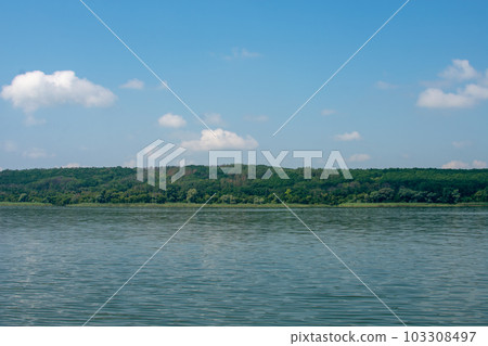Big river Oskol in the east of Ukraine. Beautiful landscape of the river against the backdrop of the forest and blue sky. 103308497