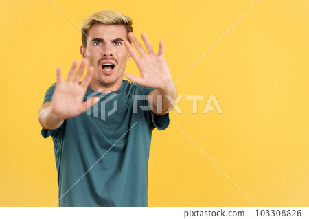 Gay man gesturing with the hands in fear 103308826