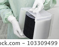 Gloved Hand Holding a Silicon Wafer in plastic holder box used in electronics for the fabrication of integrated circuits. Silicon wafer inspection. 103309499