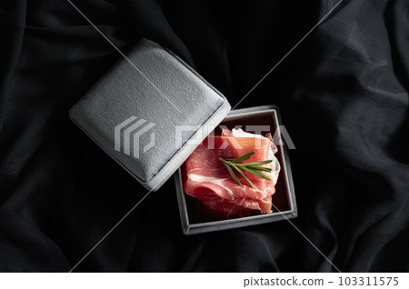 Prosciutto with rosemary in a gray gift box. Prosciutto with rosemary in a gray gift box. 103311575