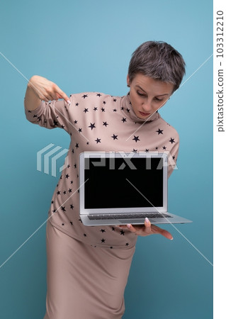 young pretty business woman with childish features with short hair showing blank screen for 103312210