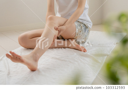 Woman doing self-massage at home Woman doing self-massage at home 103312593