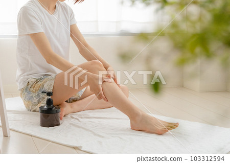 Woman doing self-massage at home Woman doing self-massage at home 103312594