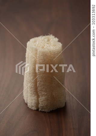 Organic loofah bath scrub on walnut table 103313692